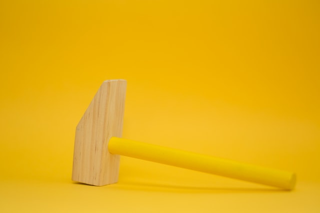 Large yellow wooden hammer